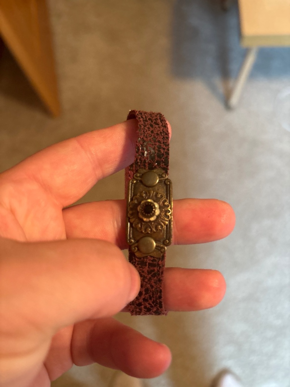 Maroon leather with brass colored center bracelet